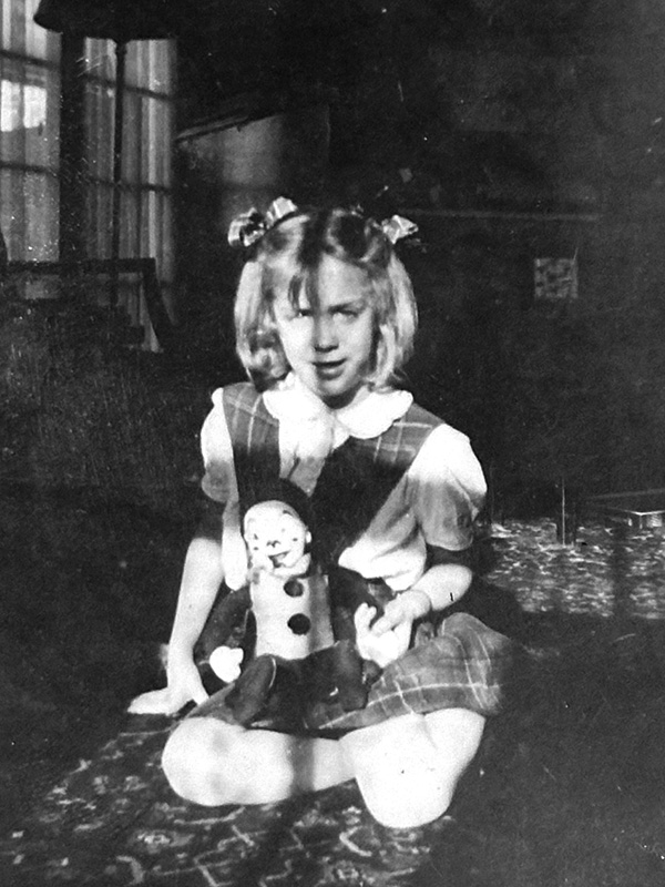 Sitting on the carpet with my new clown doll on Christmas morning.