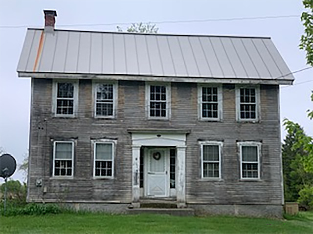 Doug�s house, the big house. It had been covered in yellow siding, which they removed.
