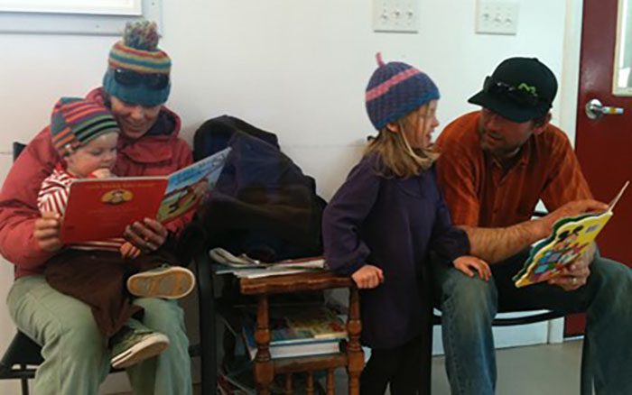  Waiting for laundry to finish&mdash;two parents, two children, two books. 